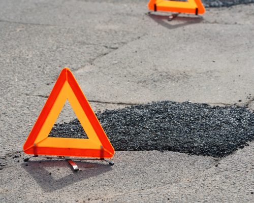 Fresh,Asphalt,Patch,Marked,By,Warning,Triangle,For,Safety.,Roadwork. Fresh,Asphalt,Patch,Marked,By,Warning,Triangle,For,Safety.,Roadwork.