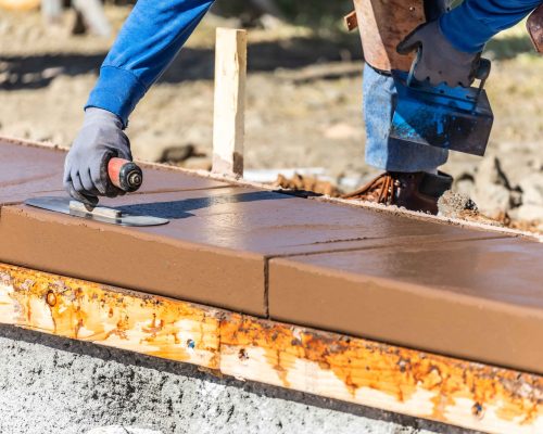 construction-worker-using-trowel-on-wet-cement-for-2024-09-11-09-13-39-utc_3_11zon
