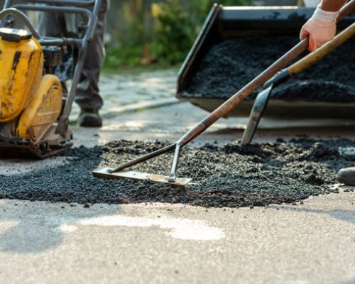 low-angle-view-of-two-workers-arranging-fresh-asph-2025-02-19-18-29-38-utc