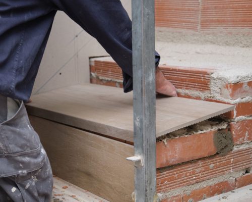 unrecognizable-bricklayer-building-a-ceramic-wood-2025-03-18-11-12-17-utc