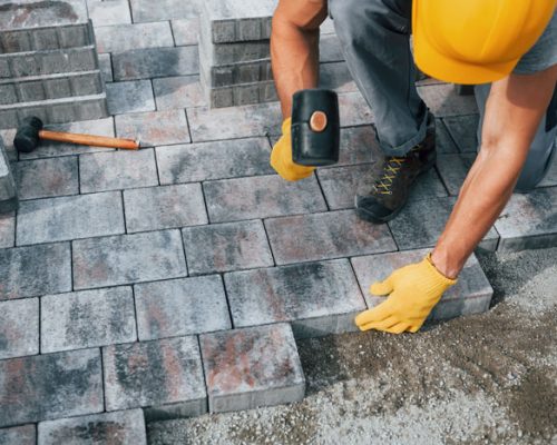 uses-a-rubber-hammer-male-worker-in-yellow-colore-2025-03-18-20-53-33-utc