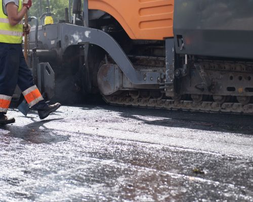 workers-operating-asphalt-paver-machine-during-roa-2025-03-09-13-27-27-utc workers-operating-asphalt-paver-machine-during-roa-2025-03-09-13-27-27-utc